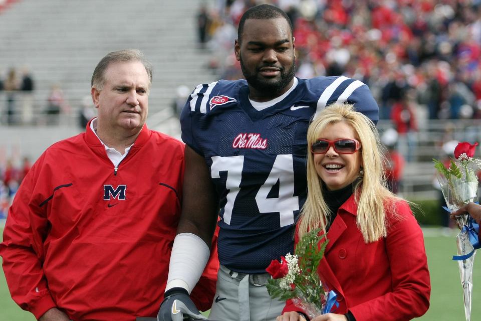 Michael Oher #74 of the Ole Miss Rebels stands with Leigh Anne Tuohy