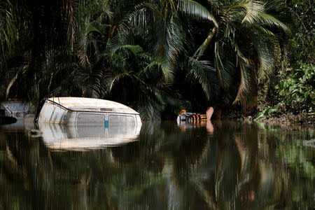 A car submerged in flood waters is seen close to the dam of the Guajataca lake after the area was hit by Hurricane Maria in Guajataca, Puerto Rico. REUTERS/Carlos Garcia Rawlins