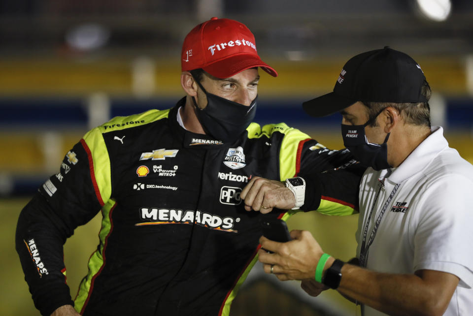 Simon Pagenaud, left, of France, celebrates in Victory Lane after winning an IndyCar Series auto race Friday, July 17, 2020, at Iowa Speedway in Newton, Iowa. (AP Photo/Charlie Neibergall)