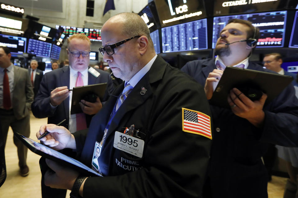 Trader Jeffrey Vazquez works on the floor of the New York Stock Exchange, Friday, Nov. 15, 2019. Stocks are opening broadly higher on Wall Street as hopes continued to grow that the U.S. and China were moving closer to a deal on trade. (AP Photo/Richard Drew)