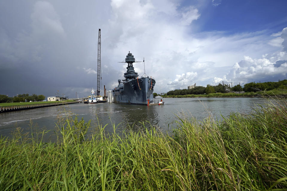 Work continues at the USS Texas in preparation for moving and repairs Tuesday, Aug. 30, 2022, in La Porte, Texas. The USS Texas, which was commissioned in 1914 and served in both World War I and World War II, is scheduled to be towed down the Houston Ship Channel Wednesday to a dry dock in Galveston where it will undergo an extensive $35 million repair. (AP Photo/David J. Phillip)