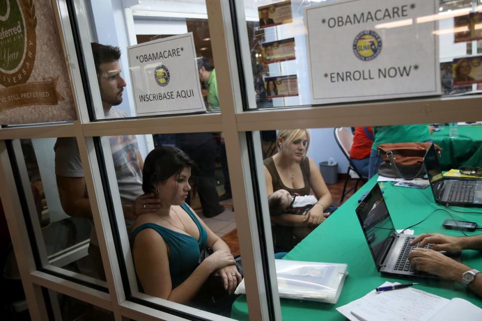 <div class="inline-image__caption"><p>(L-R) Ronnie Cabrera, Dailem Delombard and Maylin Lezcano sit with an insurance agent from Sunshine Life and Health Advisors as they try to purchase health insurance under the Affordable Care Act at the kiosk setup at the Mall of Americas on Jan. 15, 2014 in Miami, Florida.</p></div> <div class="inline-image__credit">Joe Raedle/Getty Images</div>