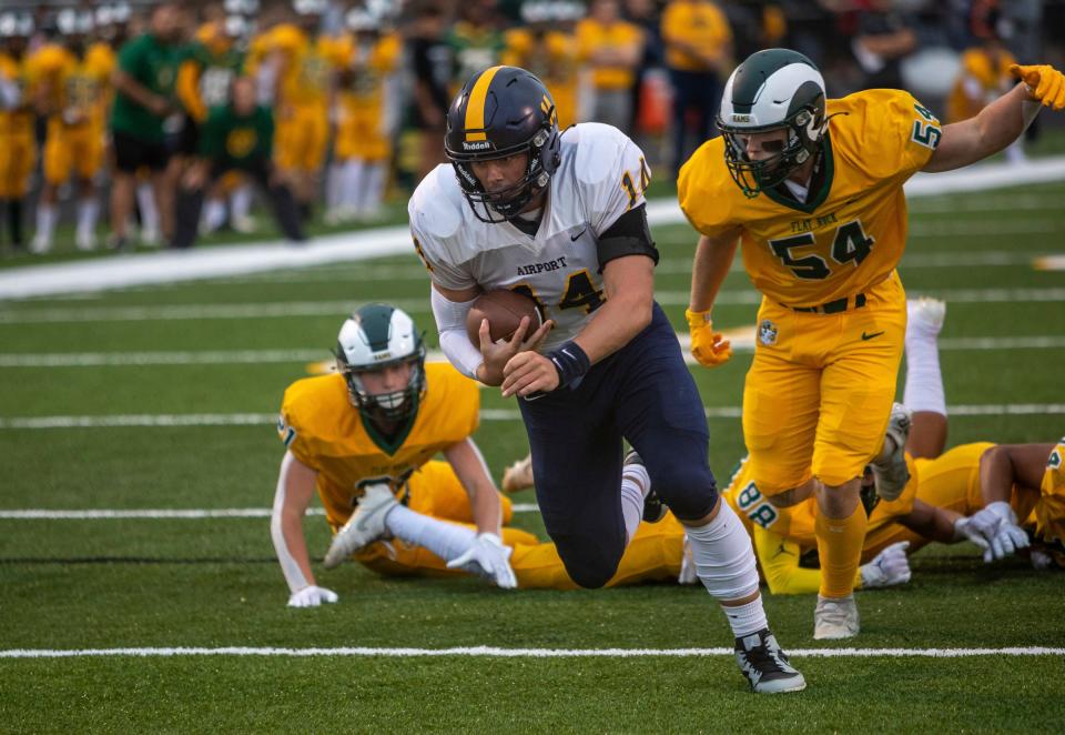 Cooper Nye (14) runs into the end zone against the Carleton Airport defense at Flat Rock High School on Friday, Sept. 8, 2023.