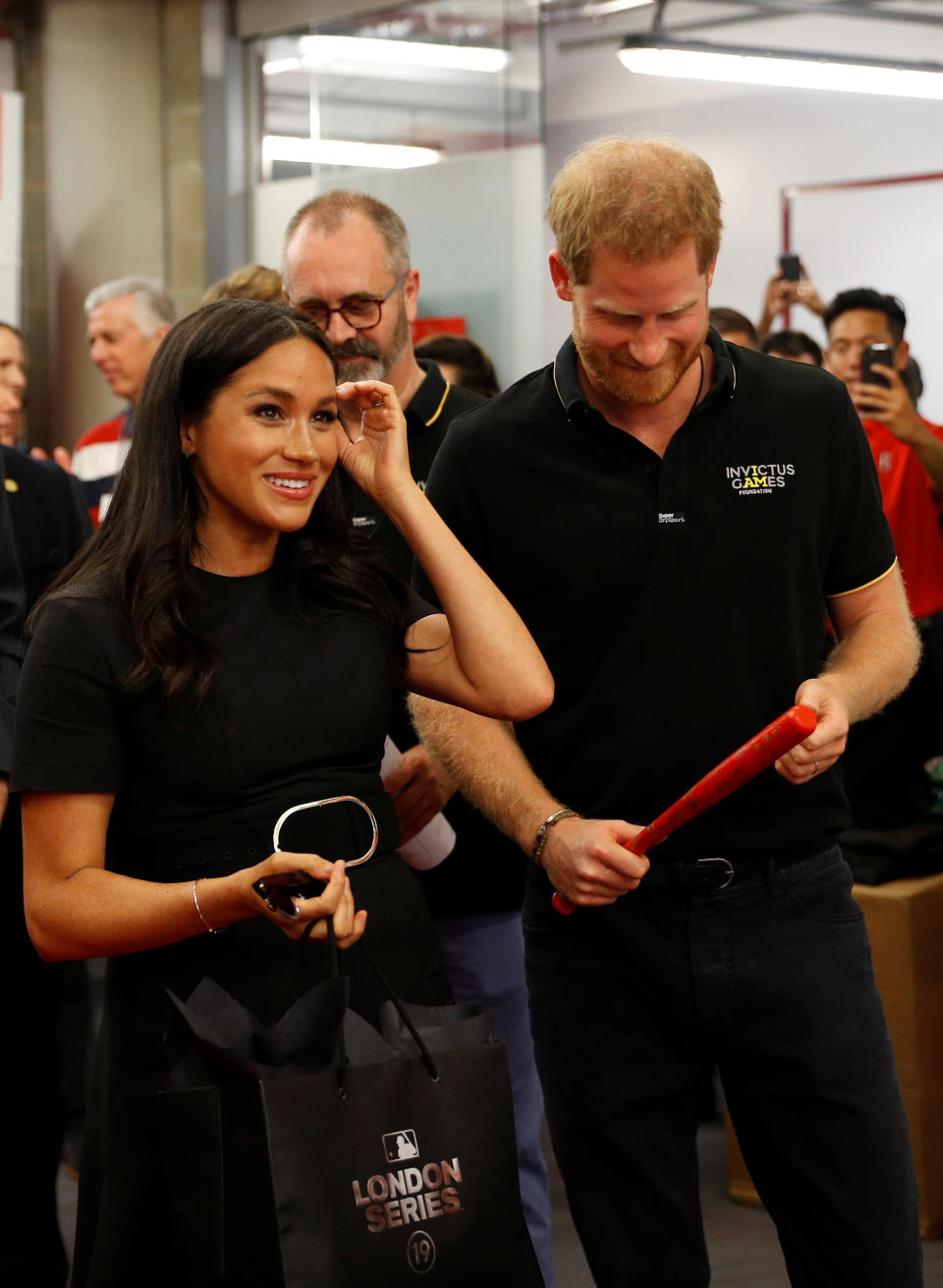 The Duke and Duchess of Sussex receive presents for their son Archie as they meet players of the Boston Red Sox as they attend the Boston Red Sox vs New York Yankees baseball game at the London Stadium in support of the Invictus Games Foundation.