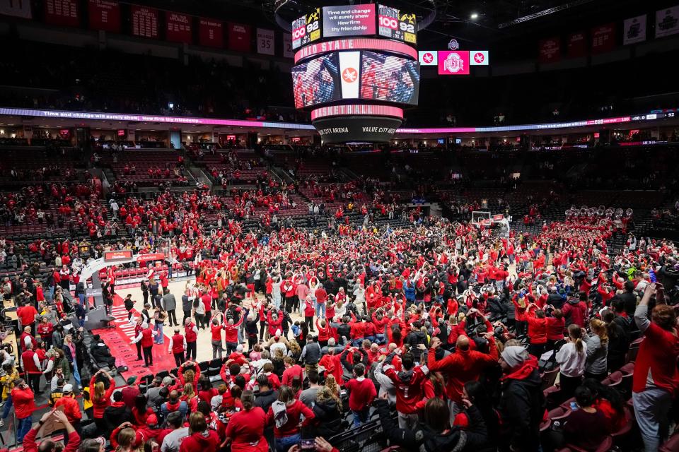 Ohio State women's basketball fans storm the court as the Buckeyes celebrate their 100-92 overtime victory over Iowa on Sunday in Columbus, Ohio.