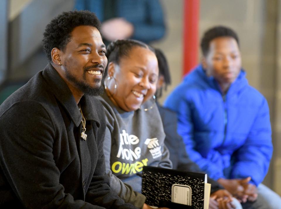 Ronnie Dykes and Ashya Mathis laugh during the dedication of their Canton home, which was built through Habitat for Humanity East Central Ohio with help from volunteers from Stark County Catholic churches.