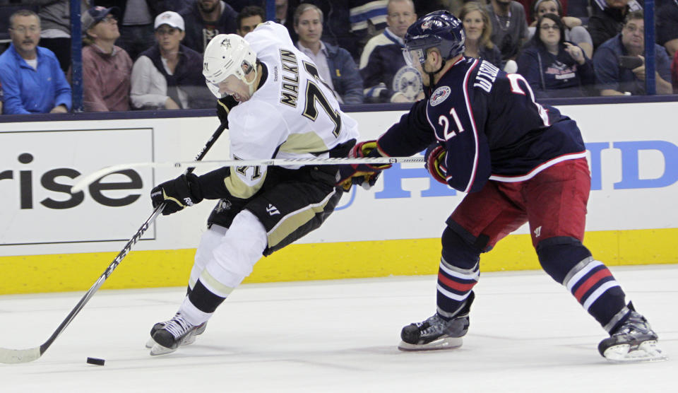 Columbus Blue Jackets' James Wisniewski, right, slashes Pittsburgh Penguins' Evgeni Malkin, of Russia, during the third period of a first-round NHL playoff hockey game Monday, April 21, 2014, in Columbus, Ohio. Wisniewski was penalized on the play. The Penguins defeated the Blue Jackets 4-3. (AP Photo/Jay LaPrete)