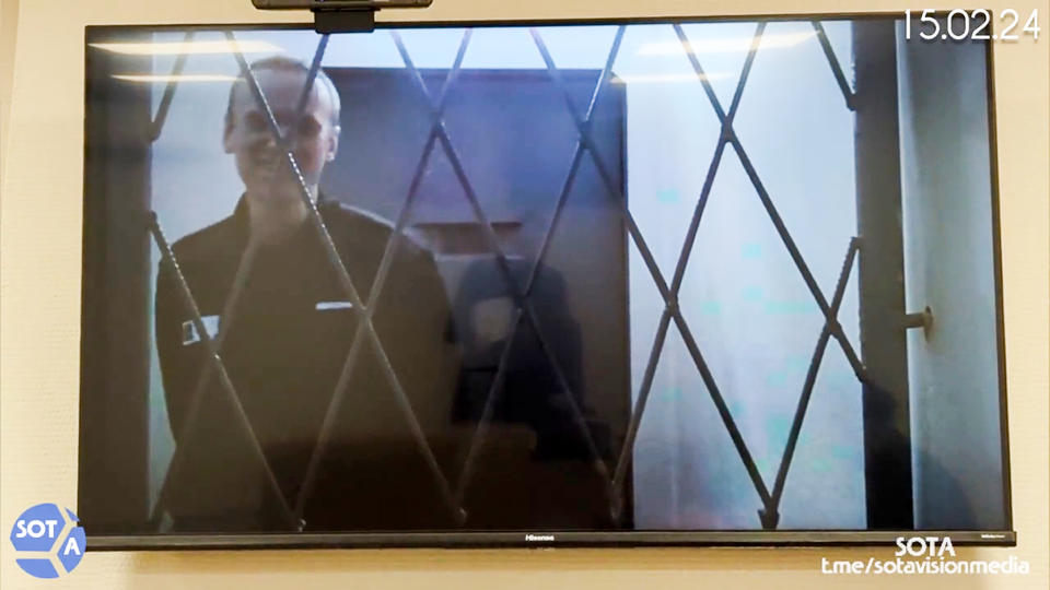 This photo taken from video released by Russian Federal Penitentiary Service via SOTAVISION shows Russian opposition leader Alexei Navalny appears via a video link from the Arctic penal colony in Kharp, in the Yamalo-Nenetsk region about 1,900 kilometers (1,200 miles) northeast of Moscow, where he is serving a 19-year sentence, in Kovrov, Russia, on Feb. 15, 2024. Shortly after Navalny's death was reported on Friday Feb. 16, 2024, the Russian SOTA social media channel shared images of the opposition politician reportedly in court yesterday. In the footage, Navalny is seen standing up and is laughing and joking with the judge via video link. (Russian Federal Penitentiary Service via SOTAVISION via AP)