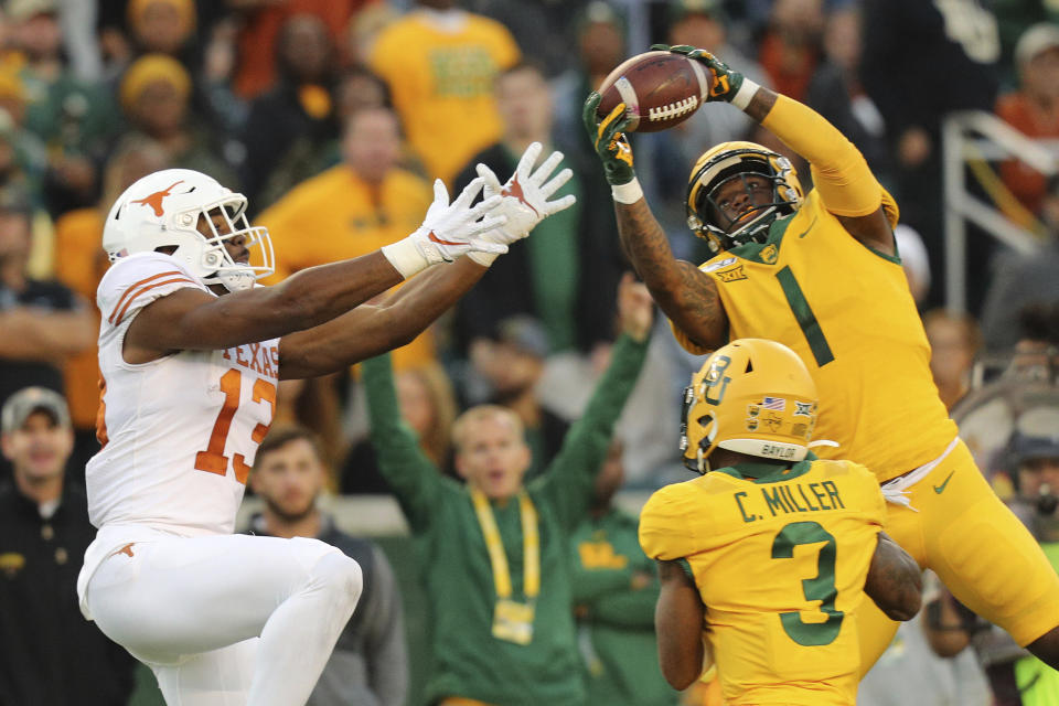 Baylor cornerback Grayland Arnold (1) intercepts a pass intended for Texas wide receiver Brennan Eagles (13) in the third quarter of an NCAA college football game Saturday, Nov. 23, 2019, in Waco, Texas. (AP Photo/Richard W. Rodriguez)