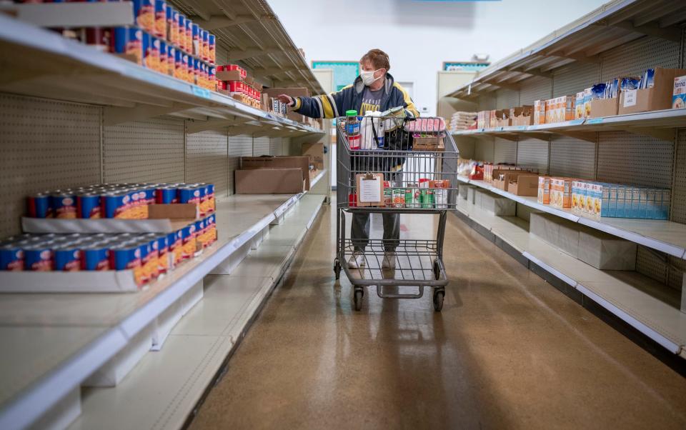 Denise Nelson, 51, of Brownstown, will be losing additional SNAP benefits provided because of the pandemic: "I will just have to stretch things, and have more meatless meals" said Nelson as she picks can goods up at Fish and Loaves, a food pantry in Taylor on Friday, March 3, 2023.