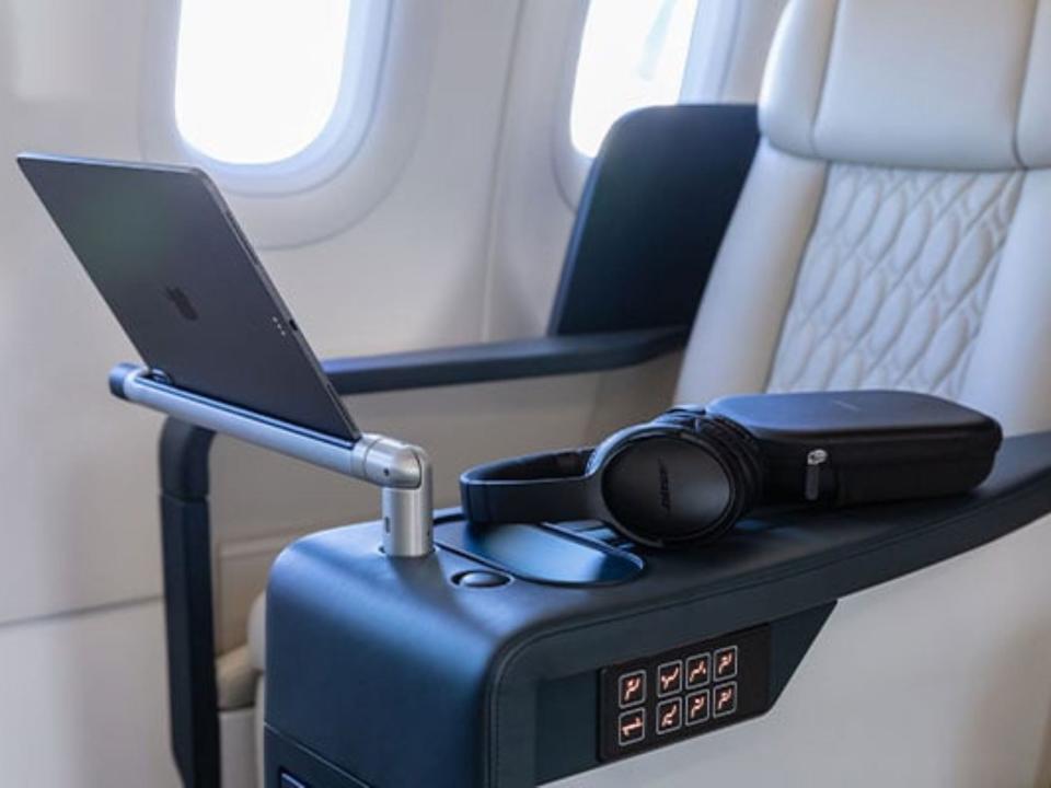 The iPad and headphones on the seat on TCS' A321 private jet.