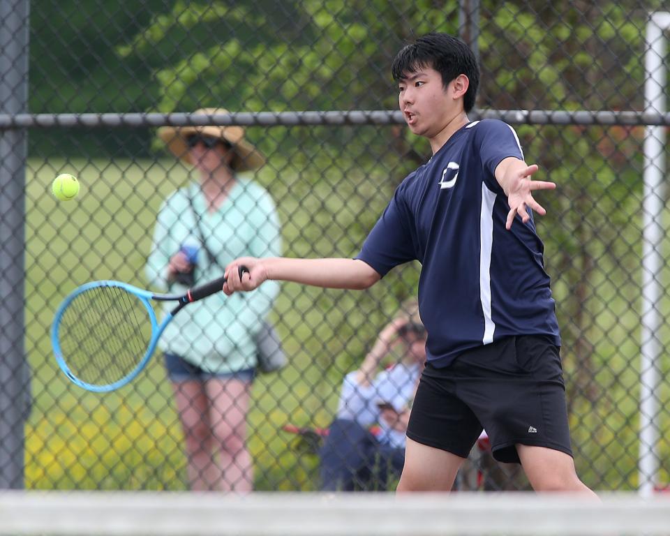 Cohasset #3 Justin Wong hits a forehand return during his match against Hingham at Hingham High School on Saturday, May 21, 2022.