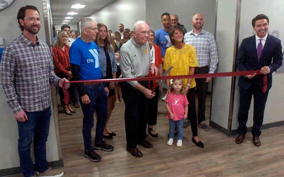 Aaron Forbes, left, Greg Gorrell, Bob Archer, Jan Archer, Riley Blair, Molly Riley, Aaron Rowsey and Matt Miller cut the ribbon at the YMCA grand re-opening ceremony Thursday.