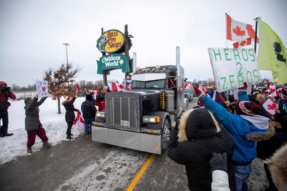 <p>People gather to support truck drivers on their way to Ottawa in protest of coronavirus disease (COVID-19) vaccine mandates for cross-border truck drivers, in Toronto, Ontario, Canada, January 27, 2022. REUTERS/Carlos Osorio TPX IMAGES OF THE DAY</p> 