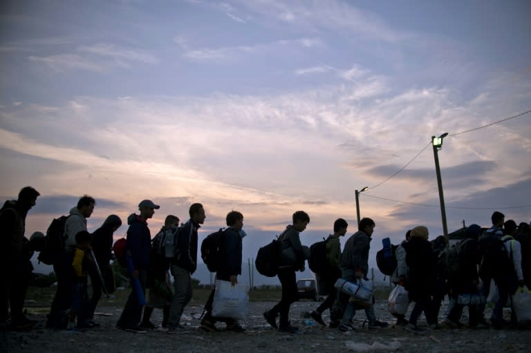 Migrants queue at a camp after crossing the Macedonian-Greek border near Gevgelija in September 2015