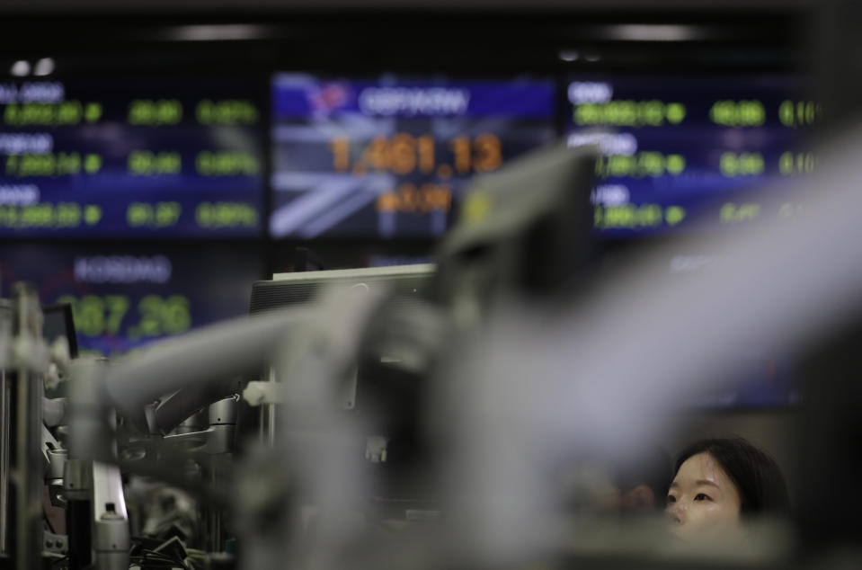 A currency trader watches the computer monitors at the foreign exchange dealing room in Seoul, South Korea, Monday, July 8, 2019. Asian stocks tumbled Monday after relatively strong U.S. employment data tempered hopes the Federal Reserve might cut interest rates. (AP Photo/Lee Jin-man)