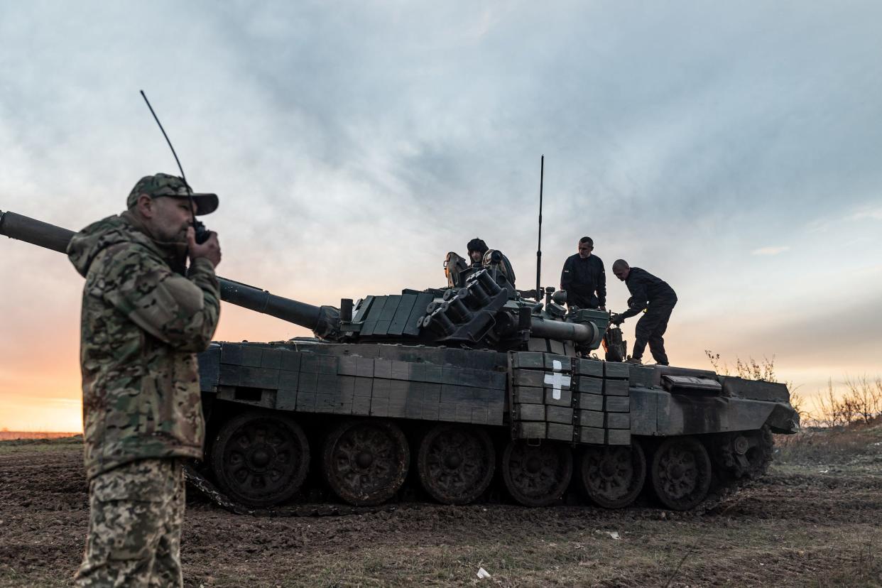 Four Ukrainian army soldiers of the 22nd Mechanized Brigade and a tank