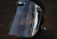 FILE - In this Aug. 24, 2020 file photo. a student, wearing a face mask and shield, returns to the Melpark Primary School in Johannesburg. The country's success in bringing its first wave of COVID-19 under control has allowed it to almost fully reopen the economy, while monitoring for signs of a second surge, says the government's chief medical advisor. (AP Photo/Denis Farrell, file)