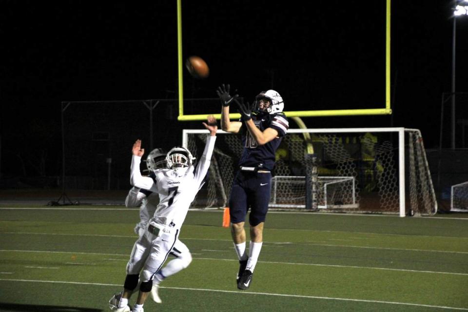 Fort Worth Covenant Classical receiver Whit Jewett catches a pass in the state quarterfinals against Longivew Heritage (Trish Wood/Courtesy)