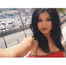 On a trip in Monaco, Jenner takes a selfie under the summer sun with jet black hair, arched eyebrows, and enviable spider lashes.