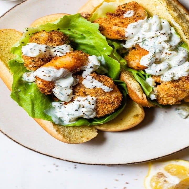 Fried shrimp sandwich with tartar sauce.