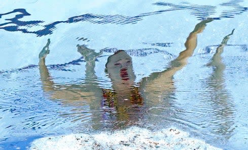 Close-up of one of the swimmers; their mouth appears wide open and very red