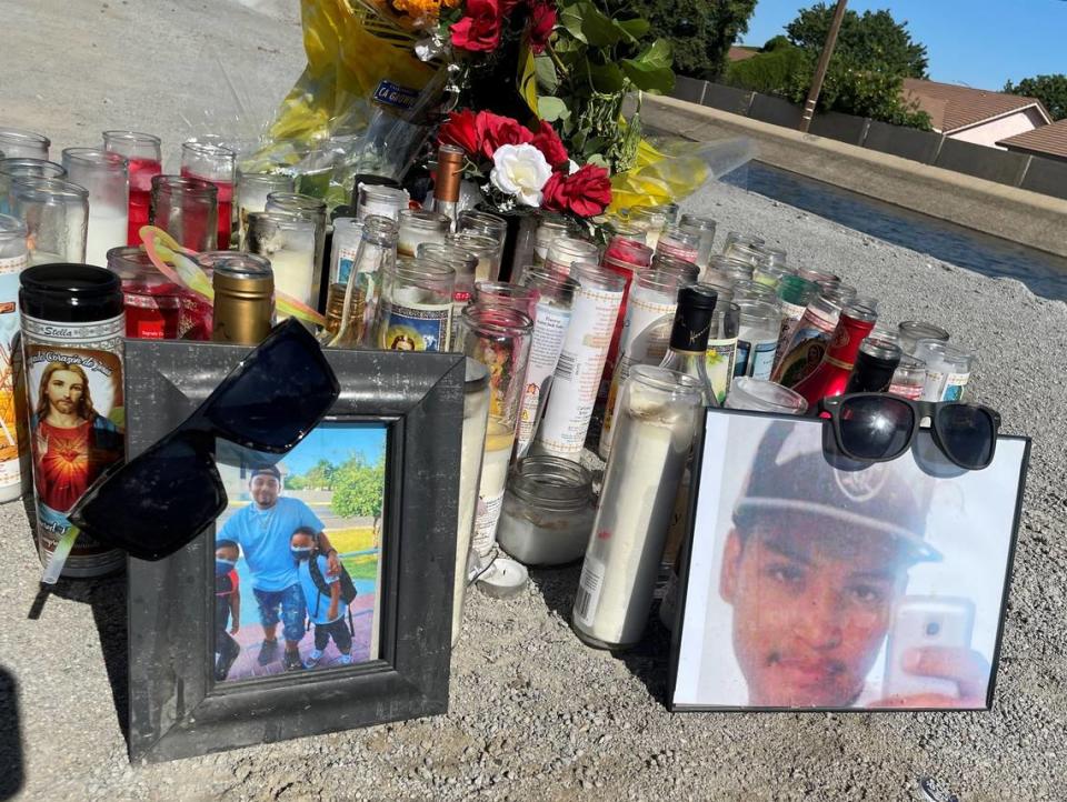 Photos of Steven Ornelas, on the left, and Oryan Ornelas sit at a memorial on a canal bank off East Briggsmore Avenue in Modesto where the cousins were killed in a crash early Sunday, May 22, 2022.