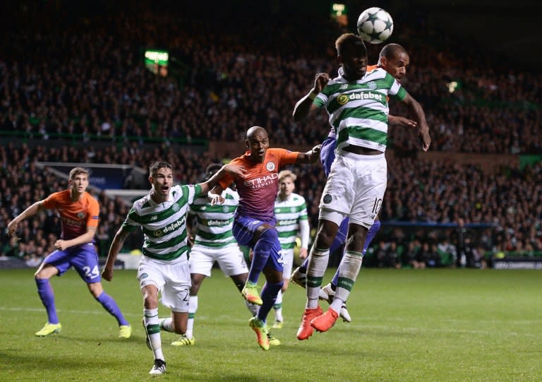 Manchester City's Brazilian midfielder Fernando (R) vies in the air with Celtic's French striker Moussa Dembele during the UEFA Champions League match in Glasgow, Scotland on September 28, 2016