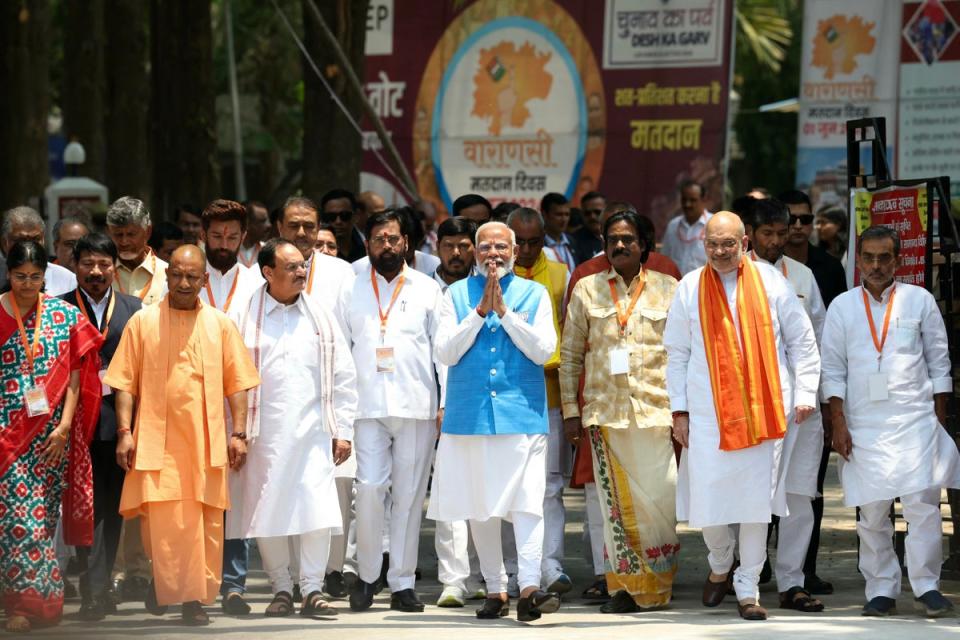 India’s prime minister Narendra Modi (C), surrounded by other party leaders and MPs including home minister Amit Shah and Uttar Pradesh chief minister Yogi Adityanath, greets supporters after filing nomination papers on 14 May 2024 in Varanasi (AFP via Getty Images)