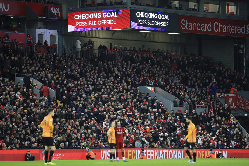 The video screens announce that a Wolverhampton Wanderers' goal is being checked, before it was disallowed for offside, during the English Premier League soccer match between Liverpool and Wolverhampton Wanderers at Anfield Stadium, Liverpool, England, Sunday Dec. 29, 2019. (AP Photo/Jon Super)
