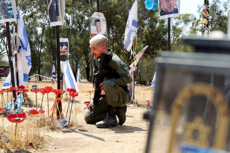 An Israeli soldier mourns at a memorial for people taken hostage or killed in Hamas's attack on the Supernova music festival on October 7, 2023, at the site of the festival near Reim, southern Israel (JACK GUEZ)