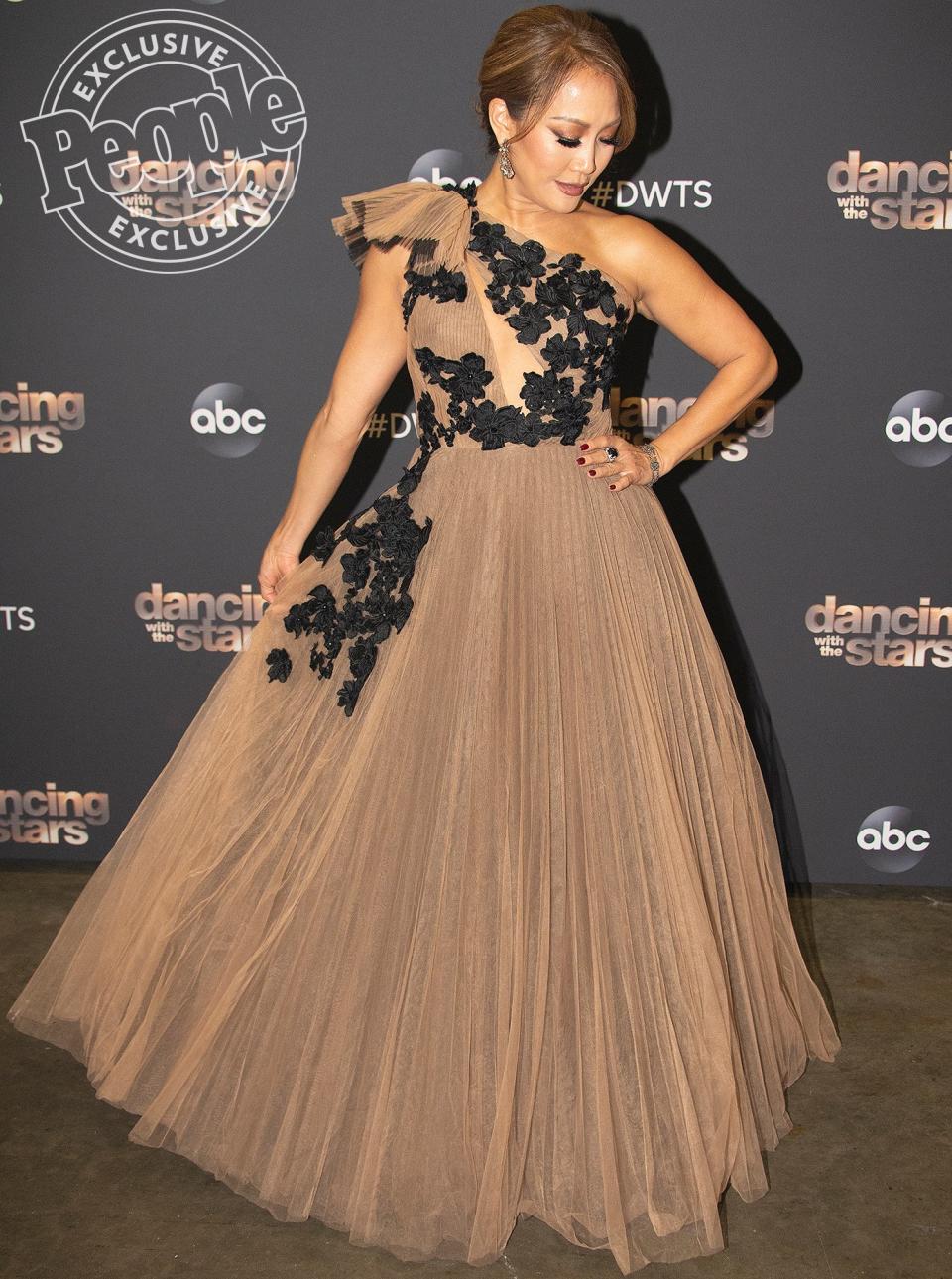 For the <em>Dancing with the Stars</em> season 28 finale, Carrie Ann’s glam squad wanted to create a look that was quintessentially her: "This <a href="https://www.noonbynoor.com" rel="nofollow noopener" target="_blank" data-ylk="slk:Noon by Noor;elm:context_link;itc:0;sec:content-canvas" class="link ">Noon by Noor</a> gown did exactly that," stylist <a href="https://www.instagram.com/rhondaspiesstylist/?hl=en" rel="nofollow noopener" target="_blank" data-ylk="slk:Rhonda Spies;elm:context_link;itc:0;sec:content-canvas" class="link ">Rhonda Spies</a> tells PEOPLE. "With a little romance, a little tulle, and a whole lotta Neil Lane, Carrie Ann closed out the season in Mirrorball style!" 