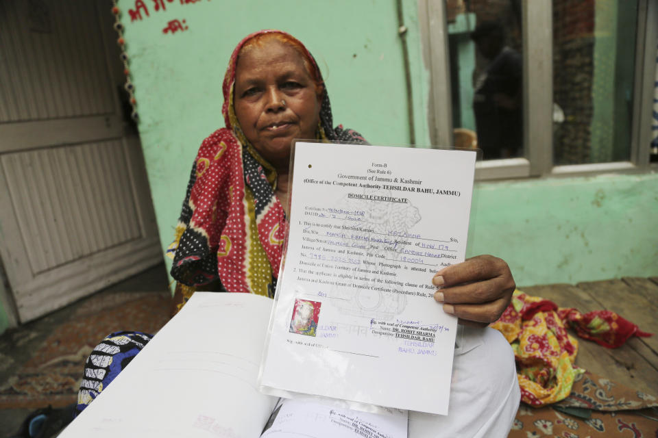 Krishna Singh shows her domicile certificate in Jammu, India, July 27, 2020. A year after India ended disputed Kashmir's semi-autonomous status and downgraded it to a federally governed territory, authorities have begun issuing residency and land ownership rights to outsiders for the first time in almost a century. Documents accessed and reviewed by The Associated Press show at least 60,000 have gained residency in the last two months including Hindu refugees, Gurkha soldiers and bureaucrats. (AP Photo/Channi Anand)