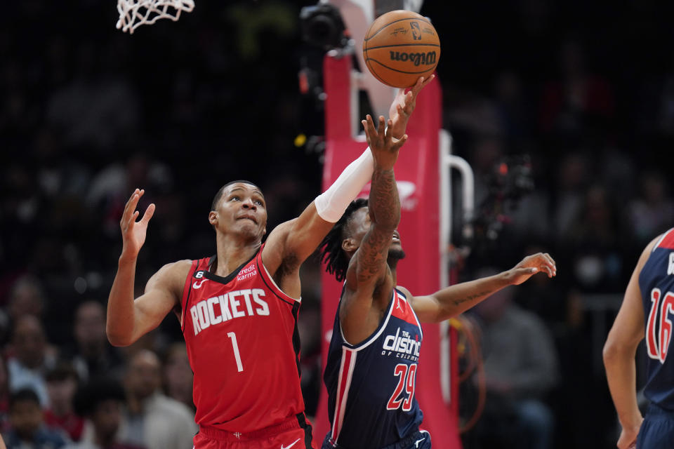 Houston Rockets forward Jabari Smith Jr. (1) and Washington Wizards guard Quenton Jackson (29) reach for a rebound during the first half of an NBA basketball game, Sunday, April 9, 2023, in Washington. (AP Photo/Jess Rapfogel)