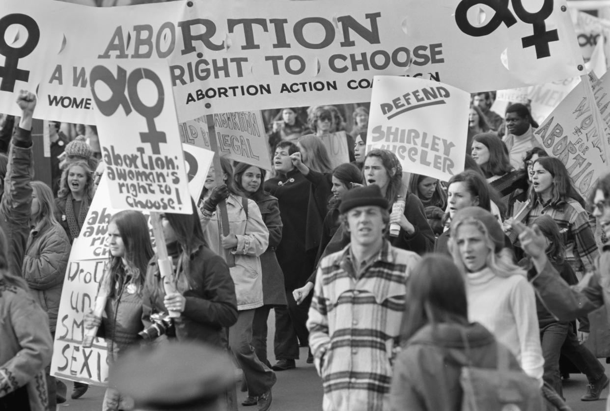 View of pro-Choice demonstrators, may with signs, as they march on Pennsylvania Avenue, Washington DC, November 20, 1970. Among the visible signs are several that read 'Abortion, A Woman's Right to Choose,' and one that reads 'Defend Shirley Wheeler,' referencing the first woman prosecuted under Florida's abortion laws (and possibly the first in the United States); she was convicted the following year. (Photo by Leif Skoogfors/Getty Images)