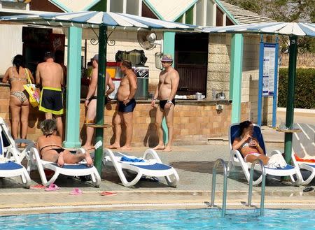 Tourists sit by the pool in a hotel at the Red Sea resort of Sharm el-Sheikh, November 7, 2015. REUTERS/Asmaa Waguih