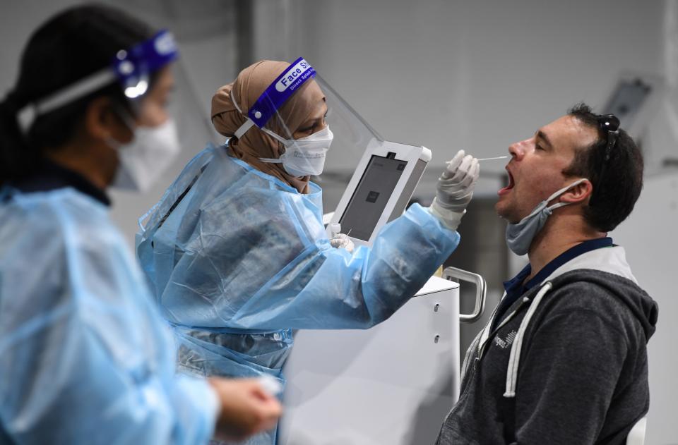 A man receives a omicron covid-19 test at an airport