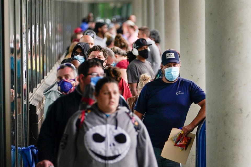 Hundreds of people line up outside a Kentucky Career Center hoping to find assistance with their unemployment claim in Frankfort, Kentucky, U.S. June 18, 2020. REUTERS/Bryan Woolston