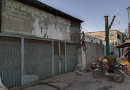 Police officers stand guard outside a morgue where the body of a Sri Lankan citizen who was lynched by Muslim mob, is kept, in Sialkot, Pakistan, Friday, Dec. 3, 2021. A Muslim mob attacked a sports equipment factory in Pakistan's eastern Punjab province on Friday, killing a Sri Lankan over allegations of blasphemy, police said. (AP Photo/Shahid Akram)