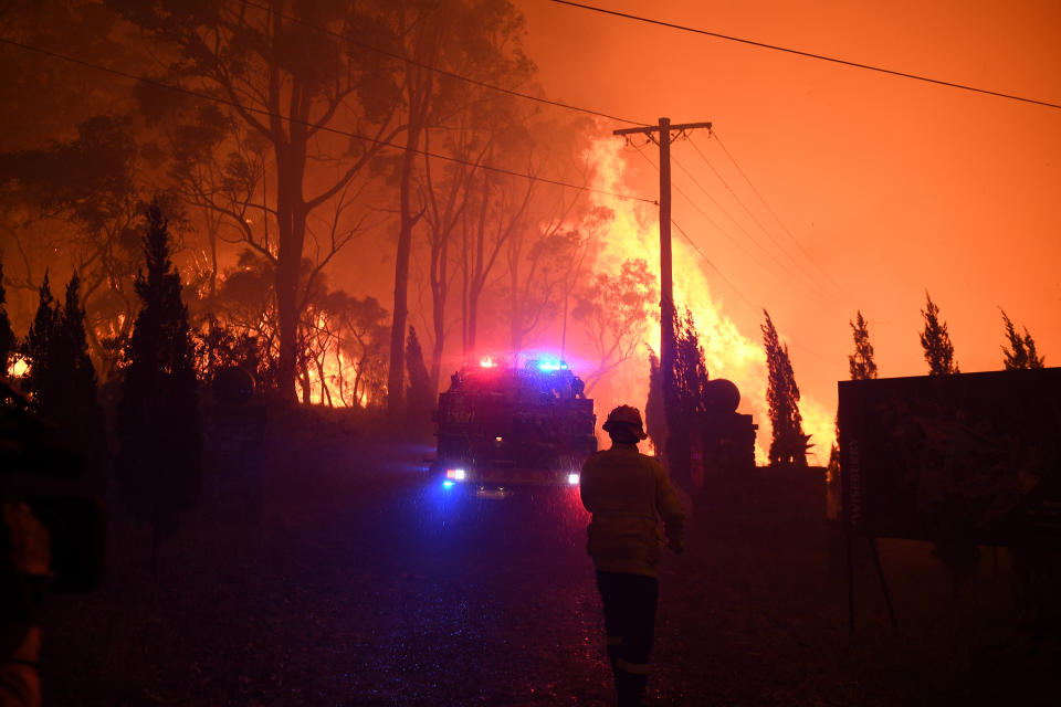 NSW Rural Fire Service crews protect properties on Waratah Road and Kelyknack Road as the Wrights Creek fire approaches Mangrove Mountain north of Sydney.