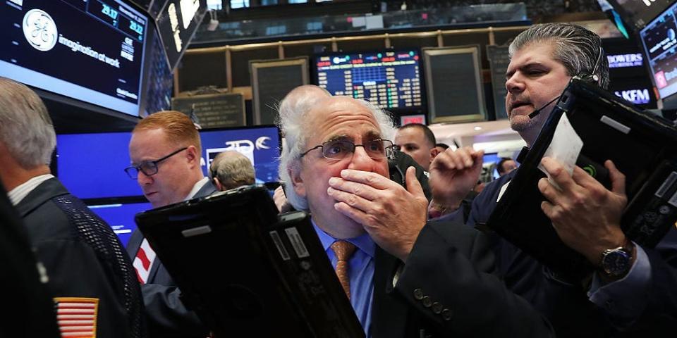 Traders work on the floor of the New York Stock Exchange (NYSE)