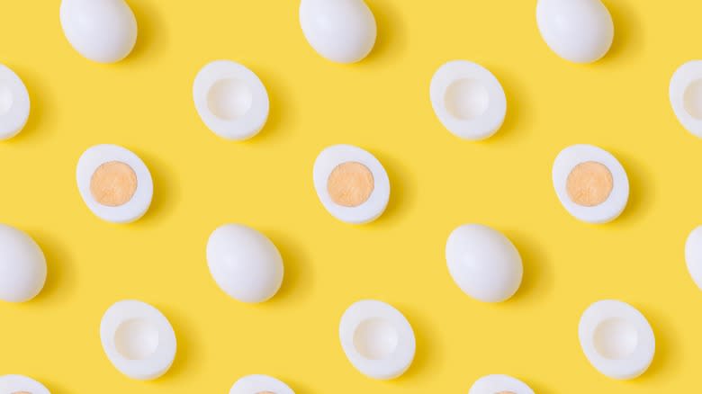 hard boiled eggs on yellow background