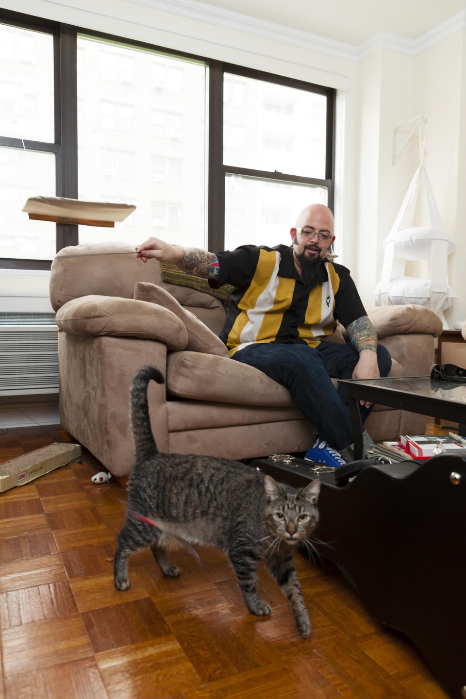 In this photo taken in late May 2012, cat behaviorist Jackson Galaxy is shown working with Oliver the cat, during production of Season 3 of Animal Planet's, "My Cat From Hell," in New York. On his TV show, he helps cats and cat owners solve behavior problems, human and feline. (AP Photo/Animal Planet)