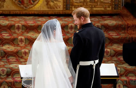 Prince Harry and Meghan Markle in St George's Chapel at Windsor Castle during their wedding service in Windsor, Britain, May 19, 2018. Owen Humphreys/Pool via REUTERS
