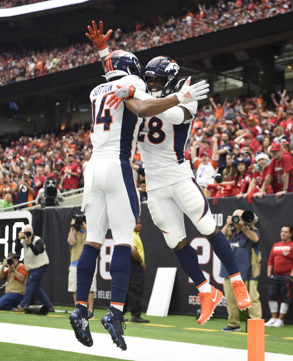 Denver Broncos running back Royce Freeman (28) celebrates his touchdown catch with teammate Courtland Sutton (14) during the first half of an NFL football game Sunday, Dec. 8, 2019, in Houston. (AP Photo/Eric Christian Smith)