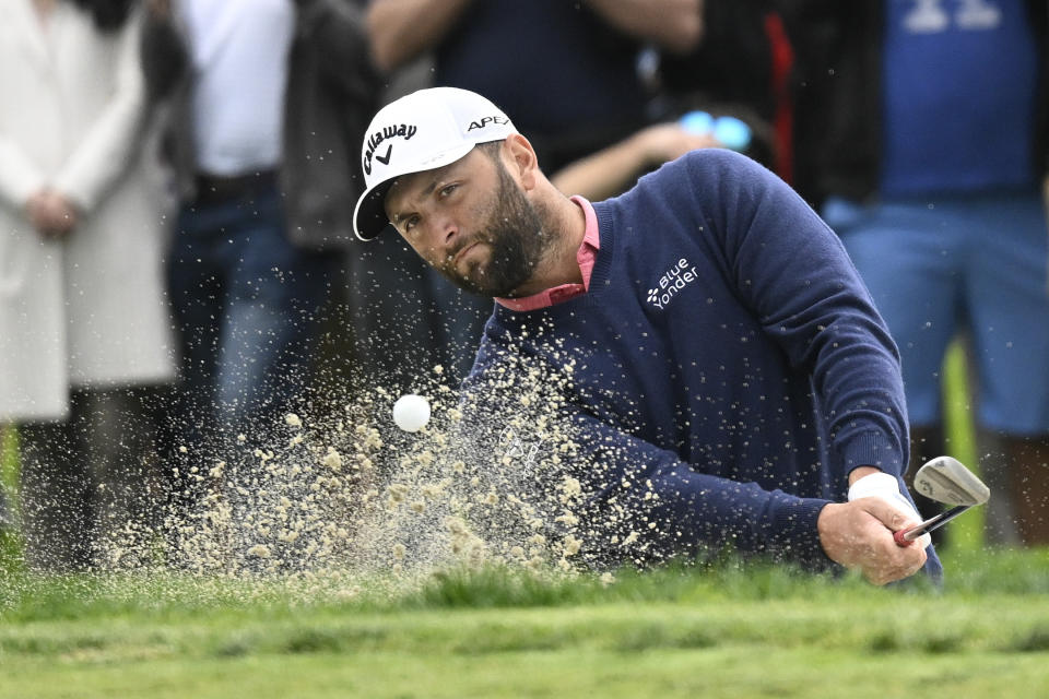 Jon Rahm of Spain hits out of the bunker on the first hole of the South Course during the final round of the Farmers Insurance Open golf tournament, Saturday, Jan. 29, 2022, in San Diego. (AP Photo/Denis Poroy)