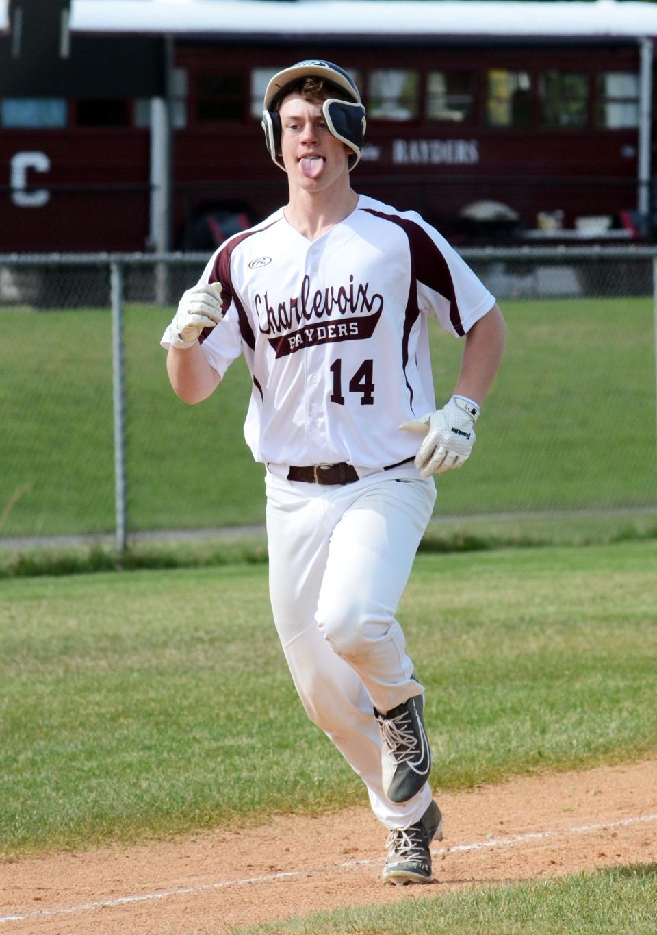 Charlevoix's Ryan Pearl rounds third and heads into home during the opener.