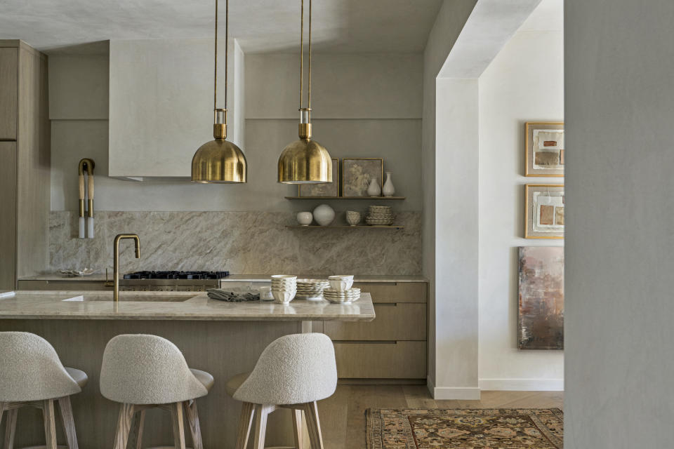 A kitchen with brass accents and textured walls