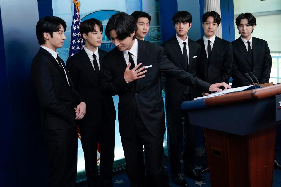 Members of the K-pop supergroup BTS join White House press secretary Karine Jean-Pierre during the daily briefing.