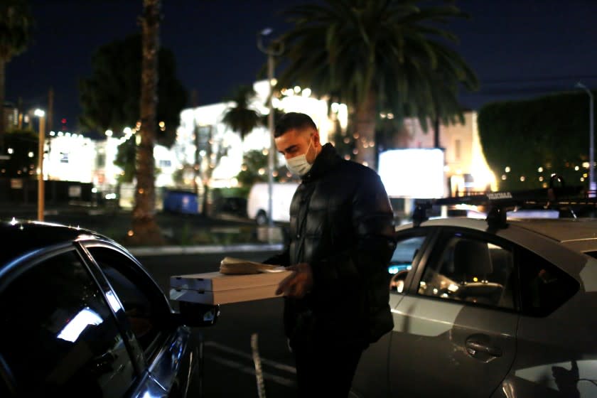 Luca Zafferano serves a customer their order at L'Antica Pizzaria Da Michele in Hollywood.